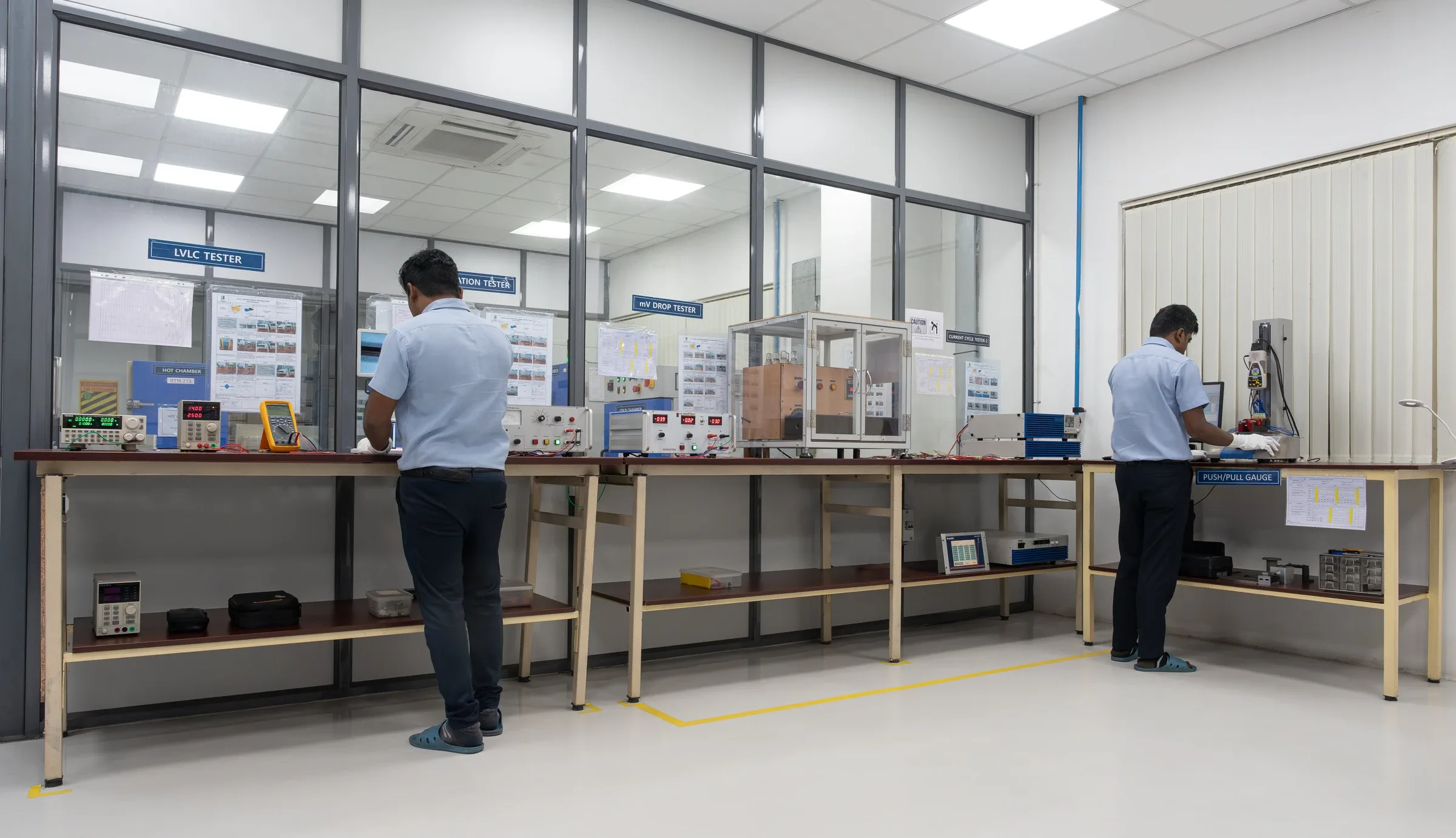 Technicians at a testing bench inside a Chennai component factory's quality lab